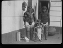 Image of Two Inuit women, girl with pup, aboard